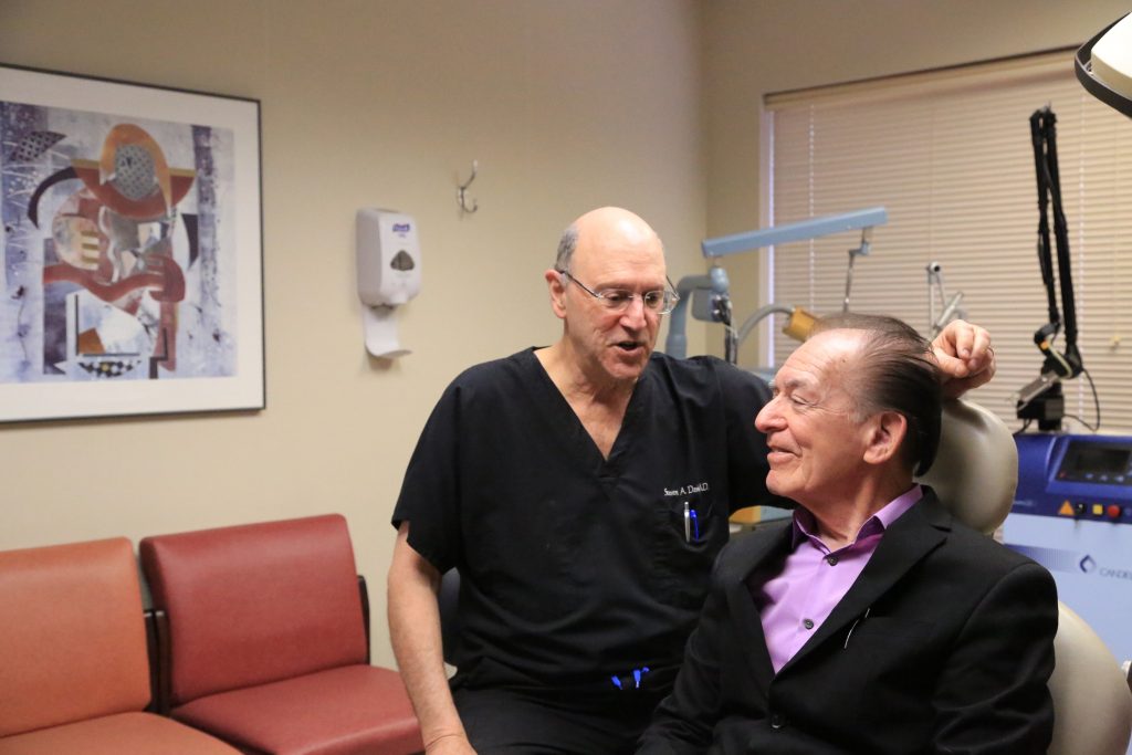 Dr. Steven A. Davis talking with a patient at the Dermatology and Laser Center of San Antonio